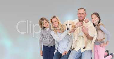 Portrait of happy family with dog against gray background