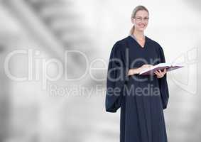 Judge holding book in front of bright staircase