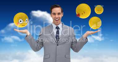 Digital composite image of emojis over hands of businessman in sky