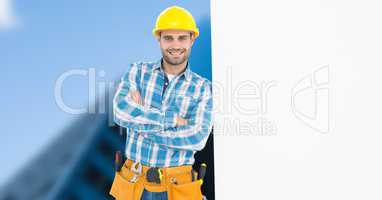 Carpenter with arms crossed leaning on blank bill board