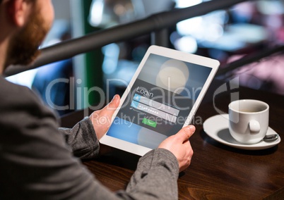 Men in a cafeteria with tablet in login screen