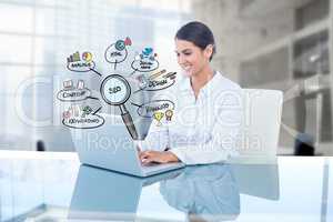 Digital composite image of businesswoman using laptop by SEO icons in office