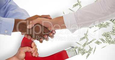 Business people shaking hands while magnet pulling money in background
