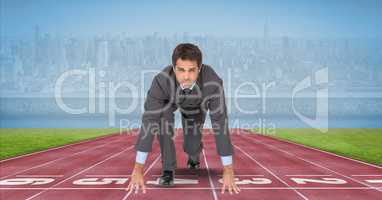 Portrait of businessman at starting line on tracks