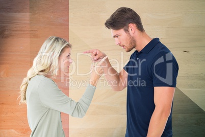 Side view of man and woman pointing while arguing
