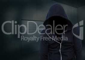 Anonymous Criminal Man in hood in front of dark room
