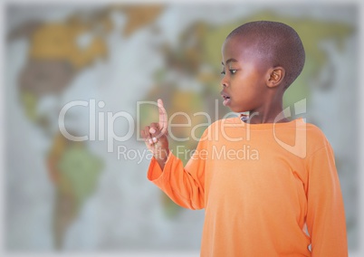 Boy pointing against blurry map