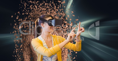 Woman wearing VR glasses with 3d scattered human figure in background