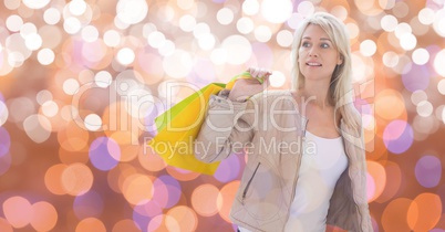 Woman looking away while holding shopping bags