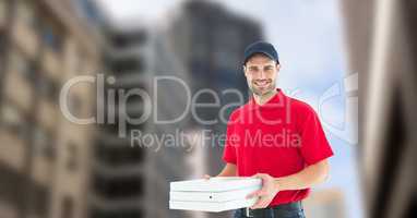 Delivery man holding pizza boxes in city