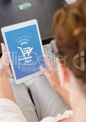 Woman using Tablet with Shopping trolley icon