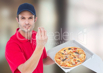 Deliveryman with pizza. Blurred background
