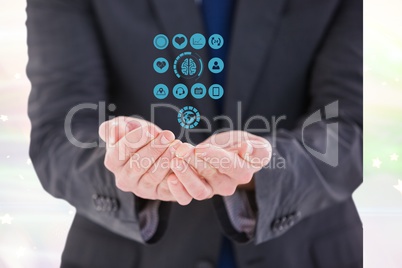Digital composite image of businessman protecting medical icons
