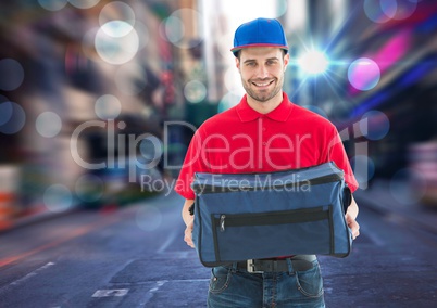 Happy pizza deliveryman with the delivery bag in the city with lights