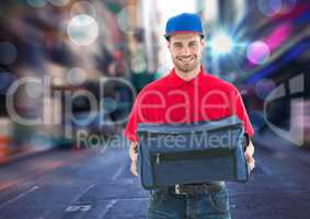 Happy pizza deliveryman with the delivery bag in the city with lights