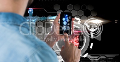 Digital composite image of man using smart phone with tech graphics in background