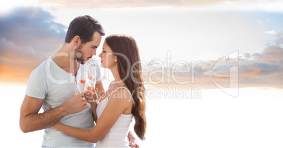 Romantic couple toasting champagne flutes against sky