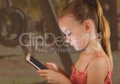 young girl on tablet with playground background
