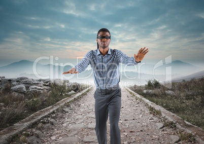 Business man blindfolded walking down road