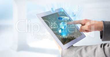 Hands touching tablet and blue graphics and flares and white background