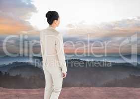 Businesswoman overlooking mountains landscape
