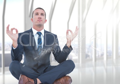 Business man with flare meditating against blurry white window