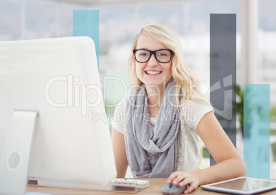 Woman at computer against blue bars in blurry office