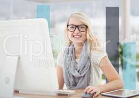 Woman at computer against blue bars in blurry office