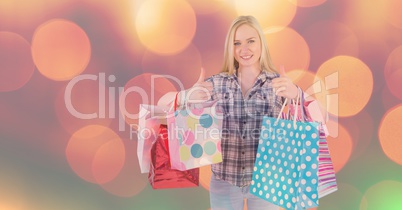 Woman with shopping bags showing thumbs up gesture