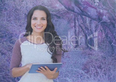 Woman on tablet with pink pink forest mysterious background