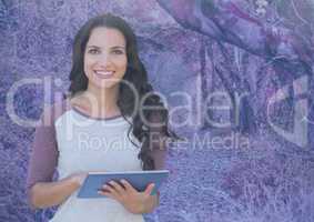Woman on tablet with pink pink forest mysterious background