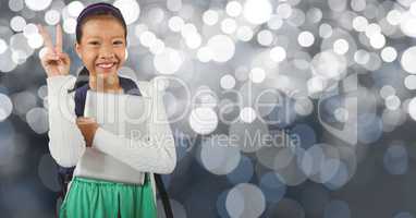 Smiling schoolgirl showing victory sign