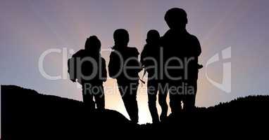 Silhouette children on mountain against sky