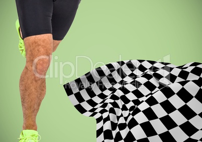 Male runner legs on start line with checkered flag against green background