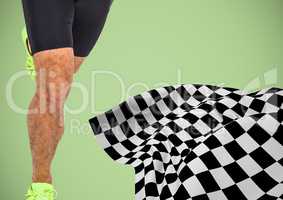 Male runner legs on start line with checkered flag against green background