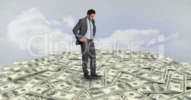Businessman standing on money