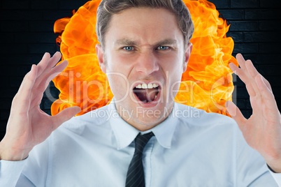 Close-up of angry businessman shouting against fire