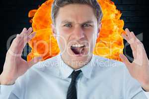 Close-up of angry businessman shouting against fire