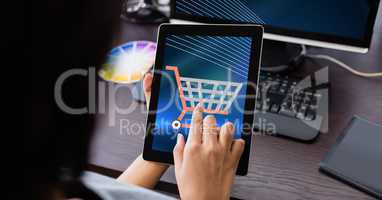 Hand touching shopping cart icon on tablet PC