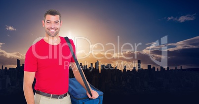 Happy pizsa deliveryman with the delivery bag on a sunset in the city