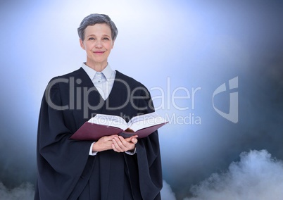 Judge holding book in front of clouds and light