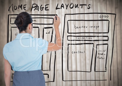 Woman with marker against website mock up and blurry wood panel