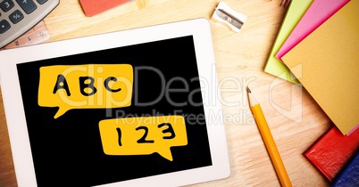 Digital composite image of digital tablet with alphabets and numbers