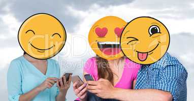Digitally generated image of friends faces covered with emoji using smart phones against sky