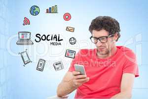 Digitally generated image of man using smart phone by various icons against blue background
