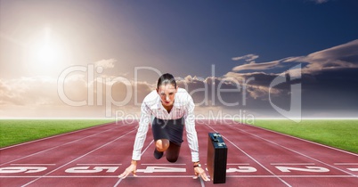 Digitally generated image of businesswoman at starting point on racing track