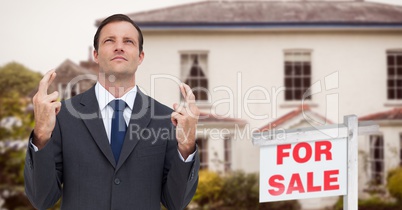 Business man with his fingers crossed, property sale