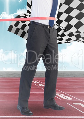 Business man at finish line on track against sky and checkered flag