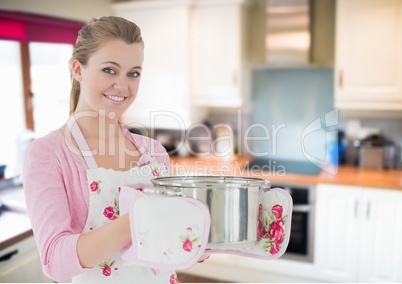 woman cooking with the saucepan in home