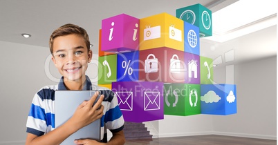 Boy holding digital tablet with application icons in background